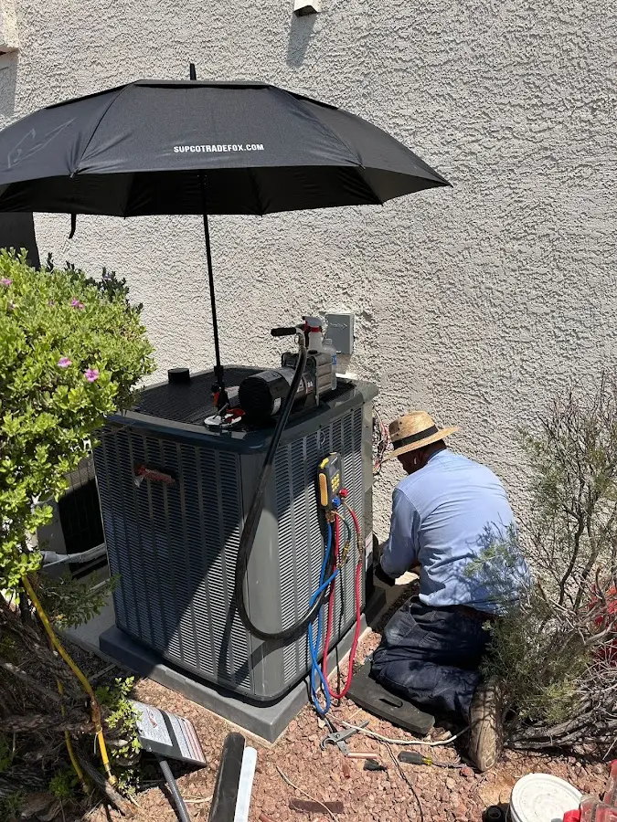 HVAC technician performing outdoor AC maintenance in Willowbrook